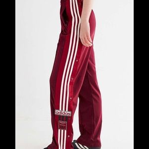 Burgundy woman’s adidas pull apart track suit pants